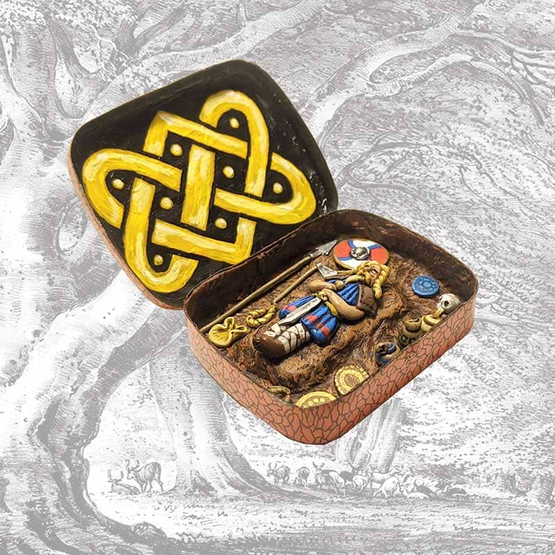Model saxon king burial in a tin with celtic knot and burial goods